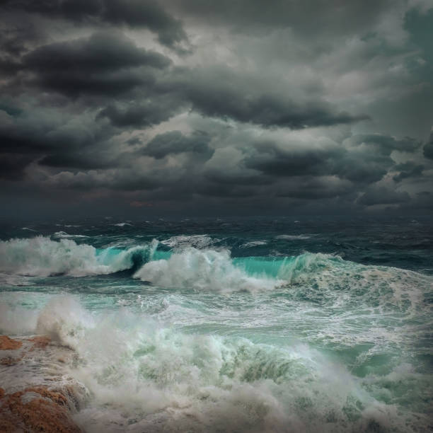 istock Stormy sea view  near coastline at evening time. Waves, splashed drops under dark dramatic sky. 1124415029
