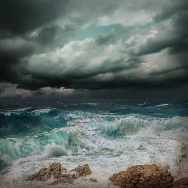 istock Stormy sea view  near coastline at evening time. Waves, splashed drops under dark dramatic sky. 1124416354