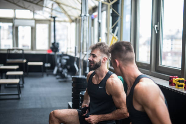 istock Two friends taking break from working out and talking in a gym 1124418218