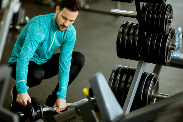 istock Handsome young man preparing dumbbells in gym 1124418520