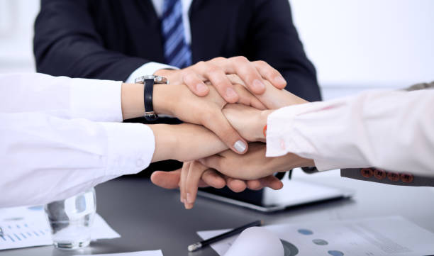 istock Business people group joining hands and representing concept of friendship and teamwork. Meeting of success team. 1124419087