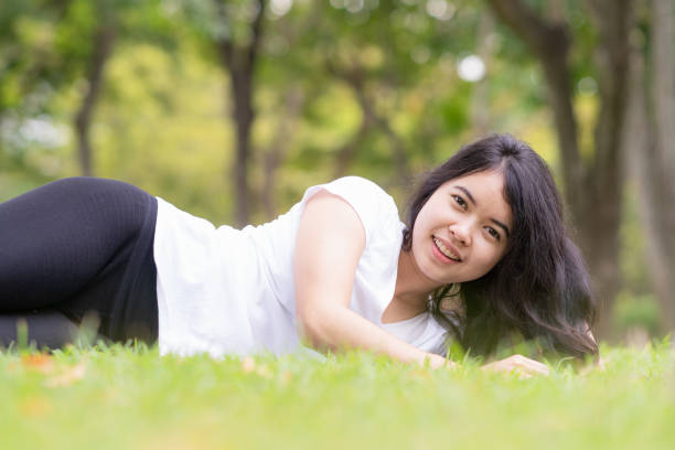 istock Young woman sleeping on green grass. 1124420063