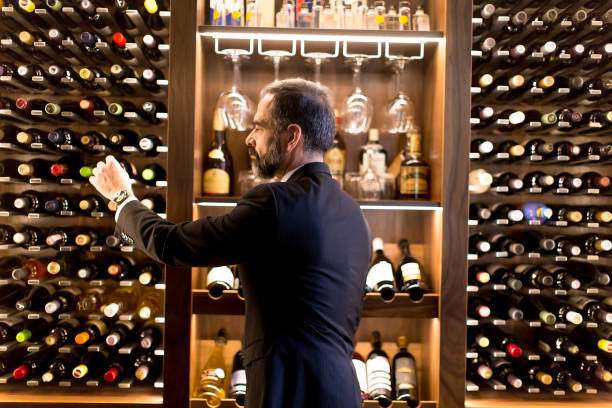 istock Man chooses a bottle of wine 1124420212