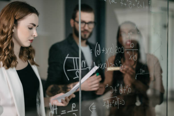 istock Professor Writing Mathematical Formulas on a glass 1124420399