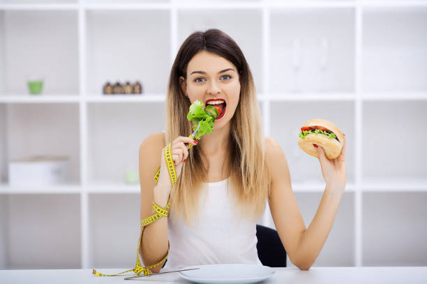 istock Choose between junk food versus healthy diet 1124420596