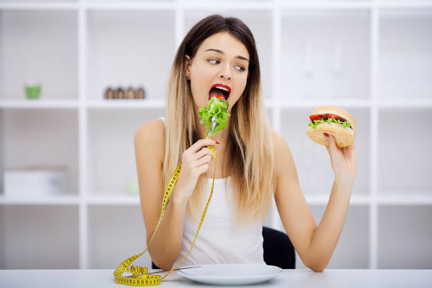 istock Choose between junk food versus healthy diet 1124420920