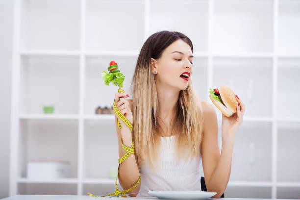 istock Choose between junk food versus healthy diet 1124421117