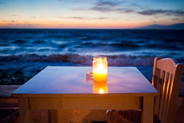 istock romantic table with burning candle by the sea at night 1124422905