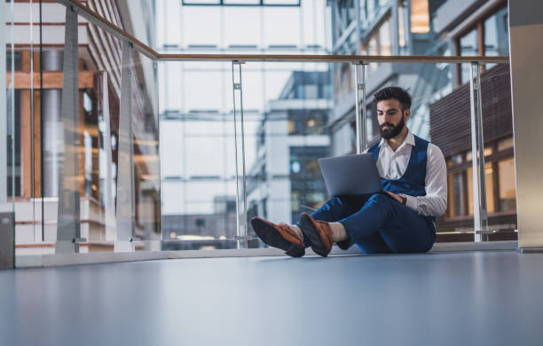 istock Young businessman working in modern building. 1124425444
