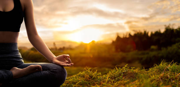 istock Young woman practicing yoga in the nature 1124425563