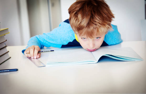 istock little boy exhausted tired of doing homework,overload 1124426116