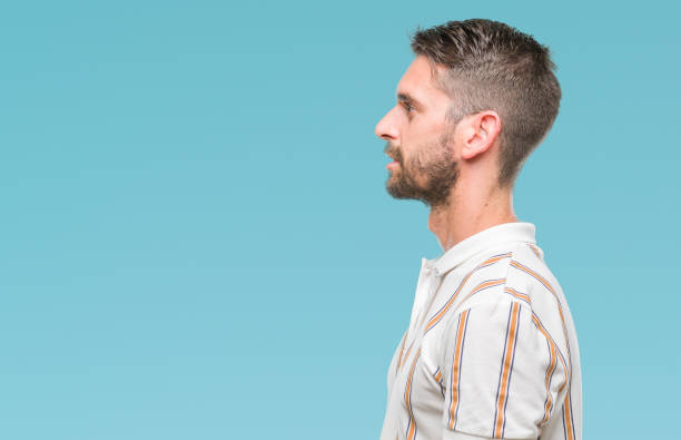 istock Young handsome man over isolated background looking to side, relax profile pose with natural face with confident smile. 1124426322