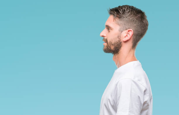 istock Young handsome man over isolated background looking to side, relax profile pose with natural face with confident smile. 1124426414
