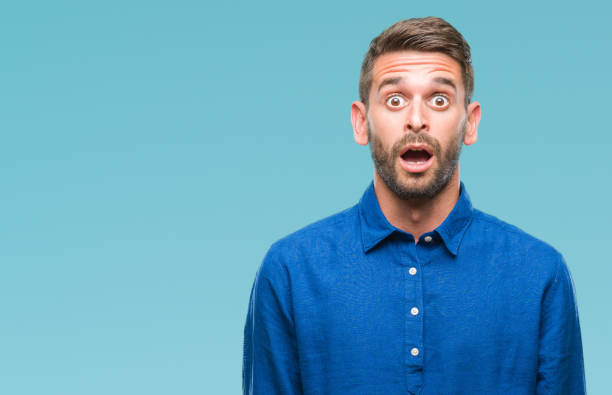 istock Young handsome man over isolated background afraid and shocked with surprise expression, fear and excited face. 1124426779