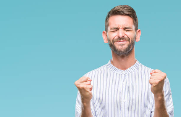 istock Young handsome man over isolated background very happy and excited doing winner gesture with arms raised, smiling and screaming for success. Celebration concept. 1124426838