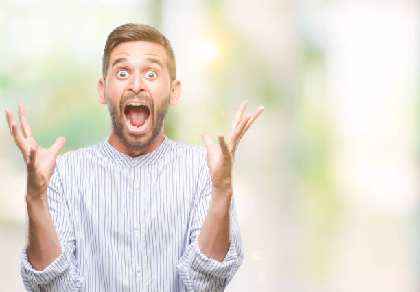 istock Young handsome man over isolated background celebrating crazy and amazed for success with arms raised and open eyes screaming excited. Winner concept 1124426889