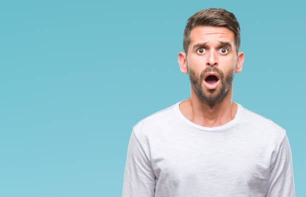 istock Young handsome man over isolated background afraid and shocked with surprise expression, fear and excited face. 1124427135