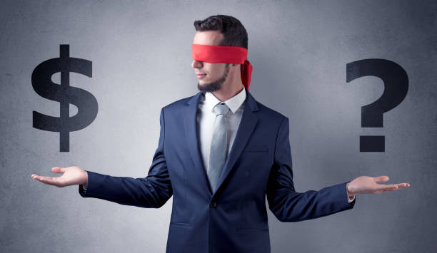 istock Man with ribbon on his eye holding dollar signs 1124427138