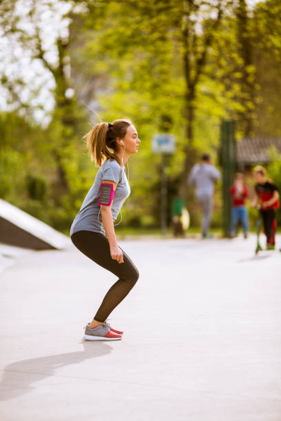 istock Young woman having exercise in the park 1124427227