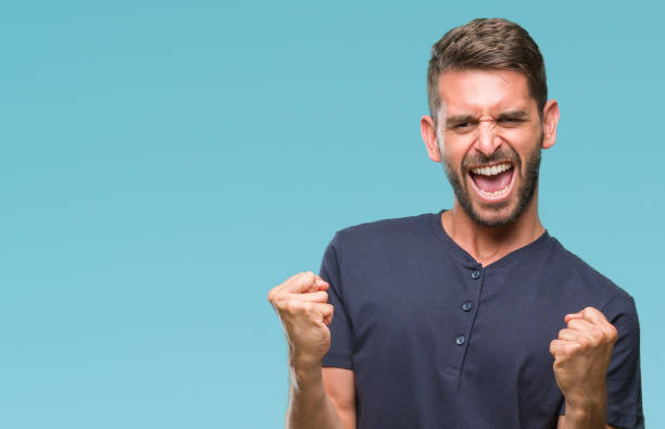 istock Young handsome man over isolated background very happy and excited doing winner gesture with arms raised, smiling and screaming for success. Celebration concept. 1124427258