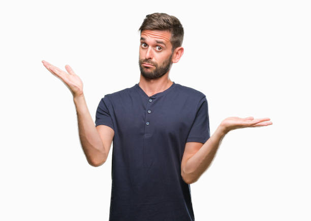 istock Young handsome man over isolated background clueless and confused expression with arms and hands raised. Doubt concept. 1124427354