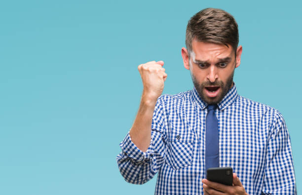 istock Young hadsome man texting sending message using smartphone over isolated background annoyed and frustrated shouting with anger, crazy and yelling with raised hand, anger concept 1124428570
