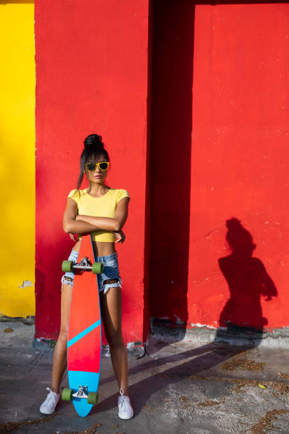 istock Woman holding scateboard 1124430016