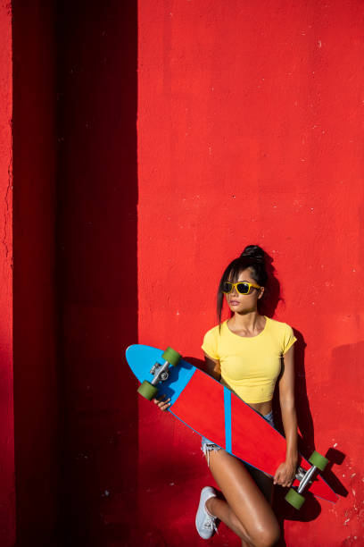 istock Woman holding scateboard 1124430030
