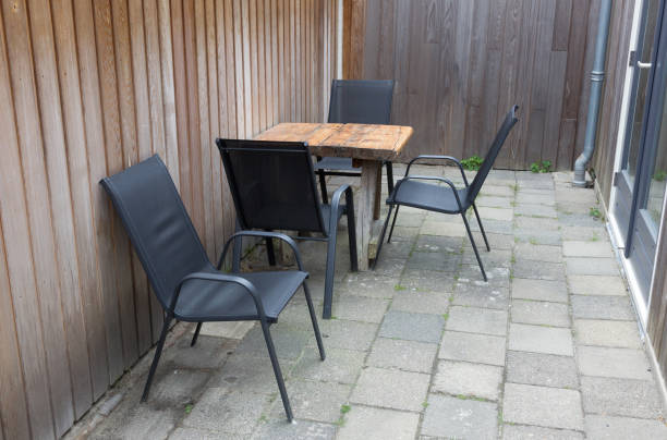 istock Table and chairs In small stone garden 1124430862