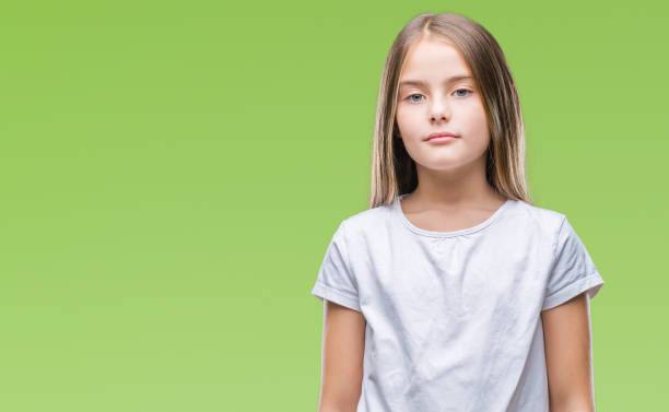 istock Young beautiful girl over isolated background with serious expression on face. Simple and natural looking at the camera. 1124431481