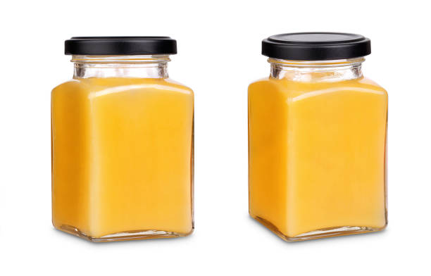 istock Square jar of honey with black cap 1124434046