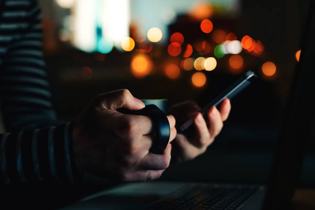 istock Woman with coffee cup looking at smartphone 1124434192