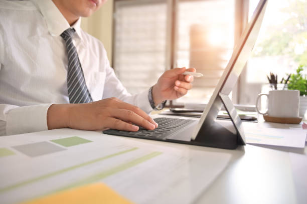 istock Businessman analysis in digital tablet on office desk. 1124434683