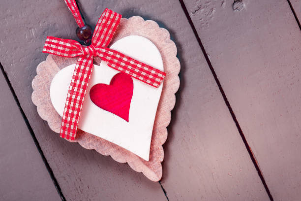 Ornate handmade heart on a painted wooden background. Space for copy.