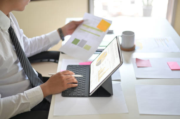 istock Businessman analyzing financial statistics displayed on the tablet screen. 1124434831