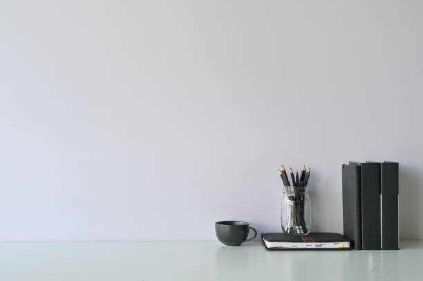 istock Mockup workspace desk and copy space books, coffee and pencil on white desk. 1124434969