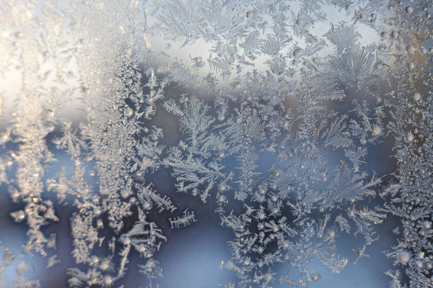 istock Christmas frosty snowflake pattern on the window glass 1124435987