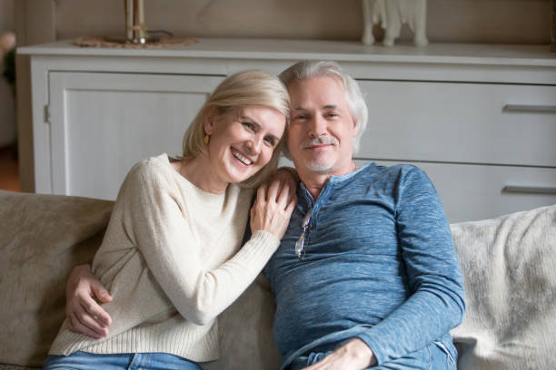 istock Wellbeing aged spouses sitting on sofa looking at camera 1124436568
