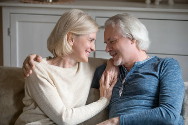 istock Blonde middle aged woman looking at husband catting together 1124436616