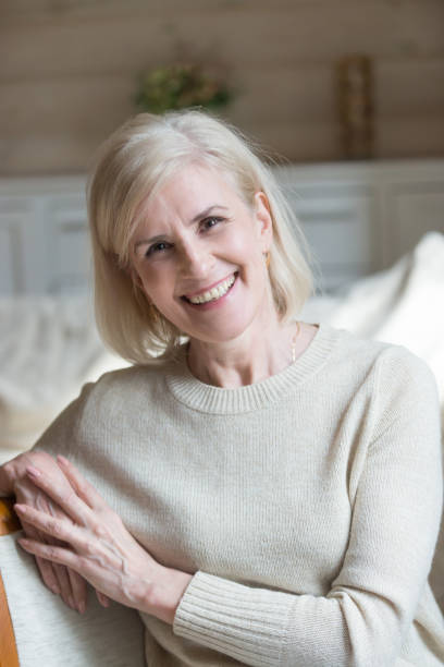 istock Vertical view happy blonde female posing for camera 1124436741