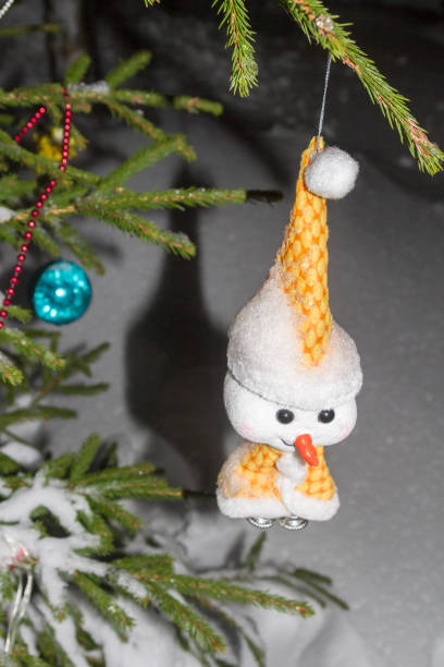 istock Christmas tree toy weighs on the tree at night in winter 1124436944