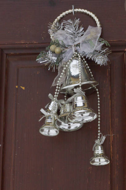 istock Silver decorative bells hanging on the door decorated 1124437180
