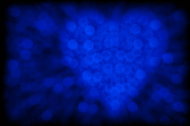 Bokeh background with blue hearts on black background. Love concept. Theme for Valentine's Day. High quality photo