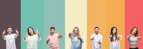 istock Collage of different ethnics young people over colorful stripes isolated background approving doing positive gesture with hand, thumbs up smiling and happy for success. Looking at the camera, winner gesture. 1124439343