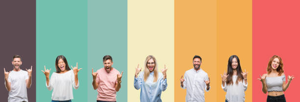 istock Collage of different ethnics young people over colorful stripes isolated background shouting with crazy expression doing rock symbol with hands up. Music star. Heavy concept. 1124439371