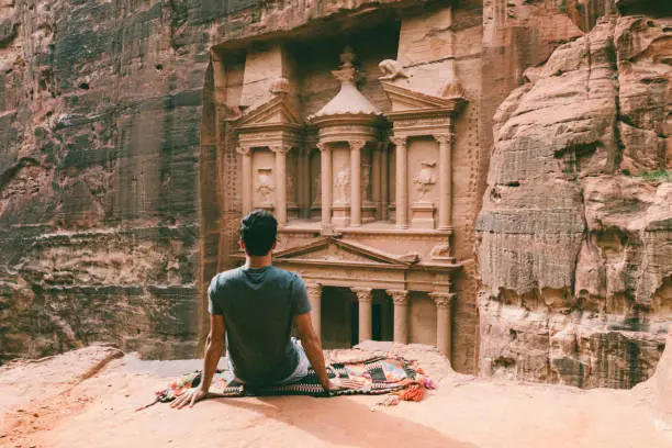 Rear view of young man admiring the Treaury of Petra, named El Khasneh al Faroun