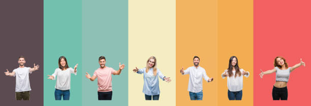 istock Collage of different ethnics young people over colorful stripes isolated background looking at the camera smiling with open arms for hug. Cheerful expression embracing happiness. 1124441046