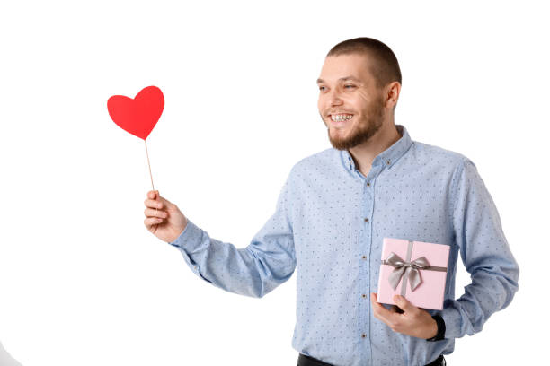 istock Young happy man holding red paper heart. 1124443690