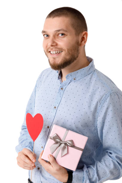 istock Young happy man holding red paper heart. 1124443713