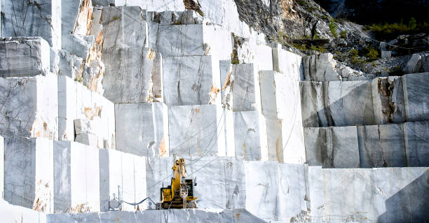 Marble quarry in Carrara, Tuscany, Italy The quarries are places where excavation and marble processing takes place for many centuries. For the way in which marble is taken, the wide spaces, the symmetrical precision of the steps, the machining plans, seem to be staged by amphitheatres. quarry stock pictures, royalty-free photos & images